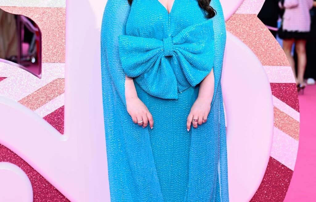 Scottish actress Sharon Rooney posing in a promotional photo for the BBC reality show Celebrity Traitors series two, Scottish actress Sharon Rooney known for My Mad Fat Diary and Barbie looking toward the camera, Official cast announcement graphic for Celebrity Traitors featuring actress Sharon Rooney, Sharon Rooney standing in front of a dark castle backdrop for The Traitors promotional material